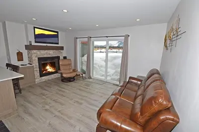 a living room with a leather couch and a fireplace at 405 Ala Wai Blvd, 180 condo in South Lake Tahoe
