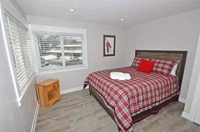 a bedroom with a bed with red pillows and a window at 405 Ala Wai Blvd, 180 condo in South Lake Tahoe