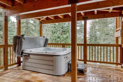 a hot tub on a screened in porch on a deck at Canterbury Lodge in Kings Beach
