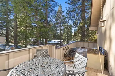 a patio with a table and chairs on a balcony at Fun & Air Conditioned Lake Tahoe 3 BR/2.5 BA Home in Incline Village