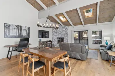 a dining room and living room with a table and chairs at Fun & Air Conditioned Lake Tahoe 3 BR/2.5 BA Home in Incline Village