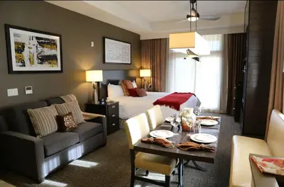 a hotel room with a bed and a dining room at Hyatt Vacation Club at Northstar Lodge in Truckee
