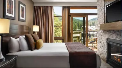 a hotel room with a bed and a fireplace at Hyatt Vacation Club at Northstar Lodge in Truckee