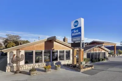 a gas station with a sign in front of it at Best Western Frontier Motel in Lone Pine