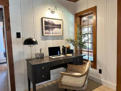 a desk with a laptop and a chair in a room at Luxury Nature Getaway Stone House by Casa Oso in Mariposa
