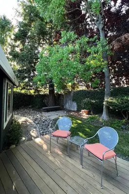 two chairs sitting on a deck in a yard at Serene Modern Family Getaway Near Midtown Downtown and Folsom Lake in Elk Grove