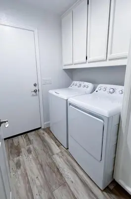a white laundry room with a washer and dryer at Serene Modern Family Getaway Near Midtown Downtown and Folsom Lake in Elk Grove