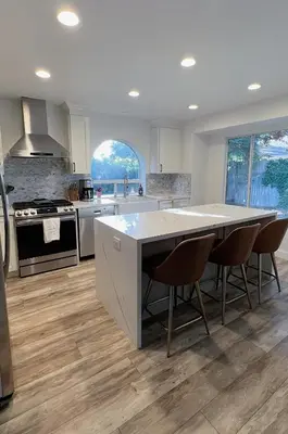 a large kitchen with a large island in the middle at Serene Modern Family Getaway Near Midtown Downtown and Folsom Lake in Elk Grove