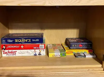 a group of books sitting on a shelf at Yosemite's Scenic Hideaway in Midpines