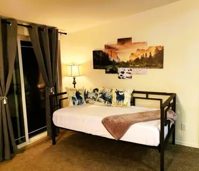 a bedroom with a bed and a large window at Yosemite's Scenic Hideaway in Midpines