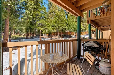a wooden porch with a table and a grill at Private/Cozy Kings Beach Retreat in Tahoe Vista