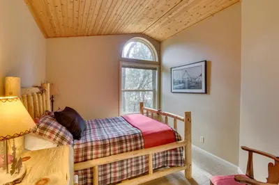 a bedroom with a bed and a window at Gas Grill and Pool Table Cabin Near Calaveras Park! in Arnold
