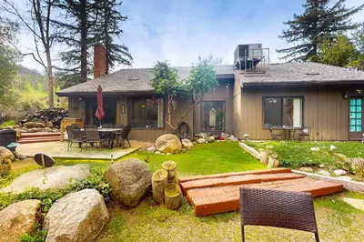 a home with a yard with rocks and a house at Yard and Patio Quiet and Well-Stocked Riverside Home in Three Rivers
