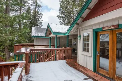 a house with a deck with snow on it at Inside Yosemite Winter Wonderland in Yosemite West