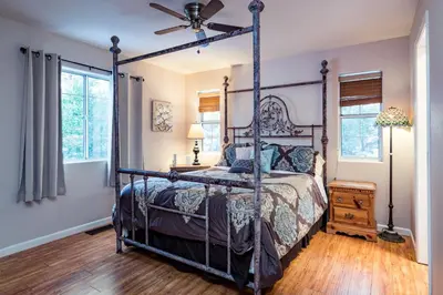 a bedroom with a canopy bed and a wooden floor at Inside Yosemite Winter Wonderland in Yosemite West