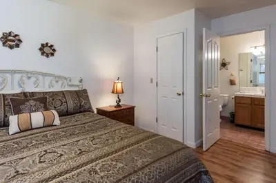 a bedroom with a large bed and a bathroom at Upper Cascades in Yosemite West