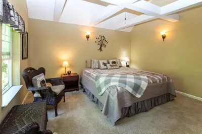 a bedroom with a bed and a chair and a window at Anderson's Alpine Retreat- Pinecrest, CA Dodge Ski in Cold Springs