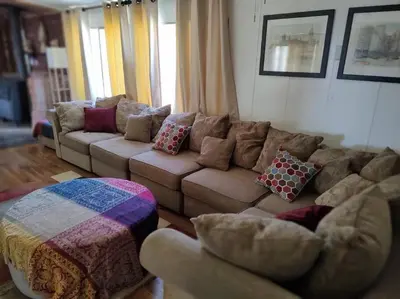 a living room with a couch with pillows at Campground at Sequoia Mountain Farms - Bring Your Own Tent or RV - No Bedrooms or Beds Provided in Miramonte