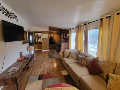 a living room with a couch and a tv at Campground at Sequoia Mountain Farms - Bring Your Own Tent or RV - No Bedrooms or Beds Provided in Miramonte