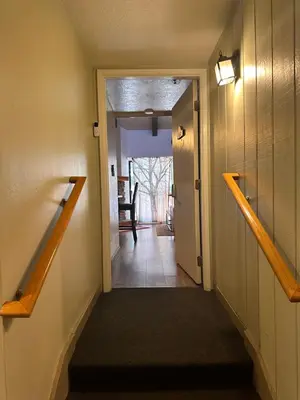a hallway with a stairway leading to a room at Yosemite Condominium Loft unit -B202 in Yosemite West