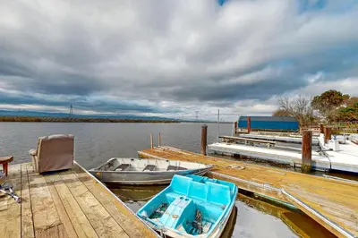 a boat is docked at a dock on the water at Riverside Retreat in Bethel Island Fish and Boat! in Bethel Island