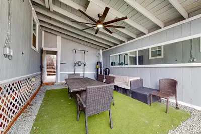 a patio with a table and chairs and a ceiling fan at Riverside Retreat in Bethel Island Fish and Boat! in Bethel Island