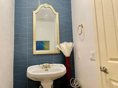 a bathroom with a sink and a mirror at Peacock House Sleeps 12 Hot Tub Game Room in Ahwahnee