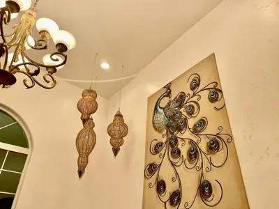 two chandeliers hanging from the ceiling in a room at Peacock House Sleeps 12 Hot Tub Game Room in Ahwahnee