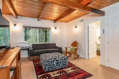 a living room with a couch and a table at Starlight Cabin in Oakhurst