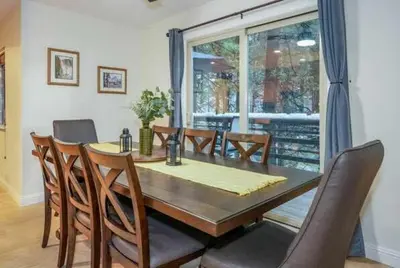 a dining room with a wooden table and chairs at Starlight Cabin in Oakhurst