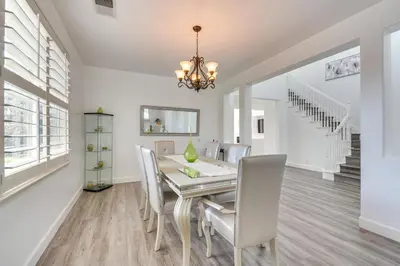 a dining room with a table and chairs at 4 Mi to Dtwn Merced Spacious Home with Yard! in Merced