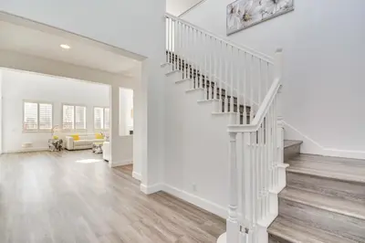 a white staircase in a home with a living room at 4 Mi to Dtwn Merced Spacious Home with Yard! in Merced