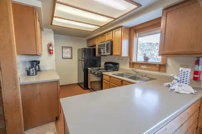 a kitchen with wooden cabinets and a white counter top at Rr-edgewater10 in June Lake