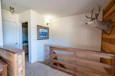 a room with a deer head hanging on the wall at Rr-edgewater10 in June Lake