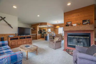 a living room with a fireplace and a tv at Rr-edgewater10 in June Lake