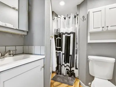 a bathroom with a toilet and a sink and a shower at Charming Retro Property 6 in Sparks