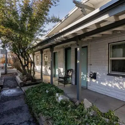 a porch of a house with a chair on it at Charming Retro Property #3! in Sparks