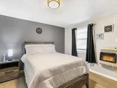 a bedroom with a large bed and a window at Charming Retro Property #3! in Sparks