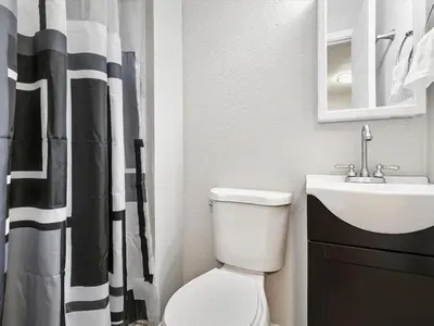 a bathroom with a white toilet and a sink at Charming Retro Property 8 in Sparks