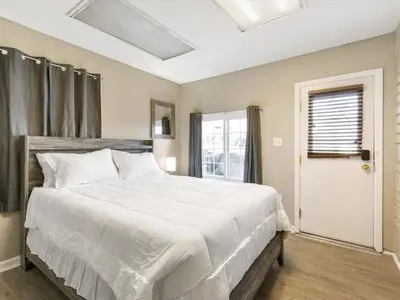a bedroom with a large white bed and a window at Charming Retro Property 22 in Sparks