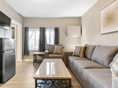 a living room with a couch and a table at Charming Retro Property 22 in Sparks