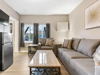 a living room with a couch and a table at Charming Retro Property 22 in Sparks