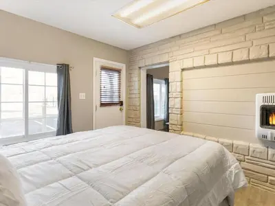 a bedroom with a large bed and a fireplace at Charming Retro Property 22 in Sparks