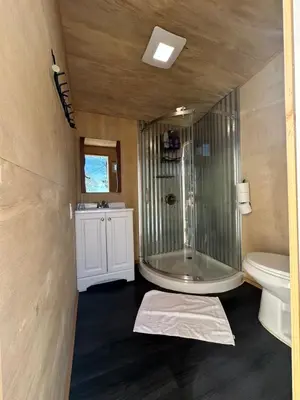 a bathroom with a glass shower and a toilet at Enchanted Forest Dome ,10-15 minutes to Kings Canyons-New pellet stove for cozy warm nights in Dunlap