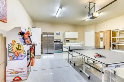 a room with a ping pong table and a refrigerator at Outdoor Oasis and Hot Tub! Spacious Clovis Home in Clovis