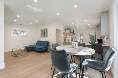a kitchen and living room with a table and chairs at East Sac Getaway, Walking Distance to Hospitals in Sacramento