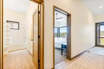 a hallway with a door leading to a bathroom at Meadowlark in Tahoe Donner - Modern 4BR w great views, hot tub & HOA amenities in Truckee