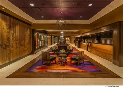 a lobby with a table and chairs on a colorful rug at Golden Nugget Lake Tahoe in Stateline