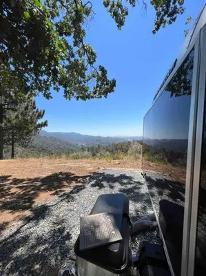 a book is sitting on the seat of a vehicle at Modern Airstream with amazing view - 10 to 15 minutes from Kings Canyon National Park in Dunlap