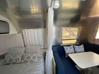 a living room with a couch and a table at Modern Airstream with amazing view - 10 to 15 minutes from Kings Canyon National Park in Dunlap